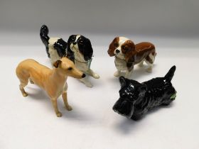 Four boxed Beswick dogs, spaniels, scottie and greyhound.