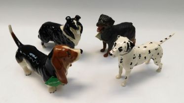 Collection of four boxed Beswick dogs, sheepdog, Rottweiler, Basset and Dalmatian.