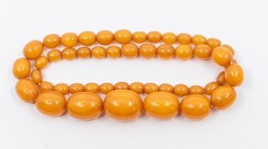 A bead necklace, comprising graduated butterscotch coloured oval beads the largest approx 24 x 19mm,