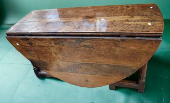 An 18th Century provincial large oak gate leg table, 142cm long x 72cm high