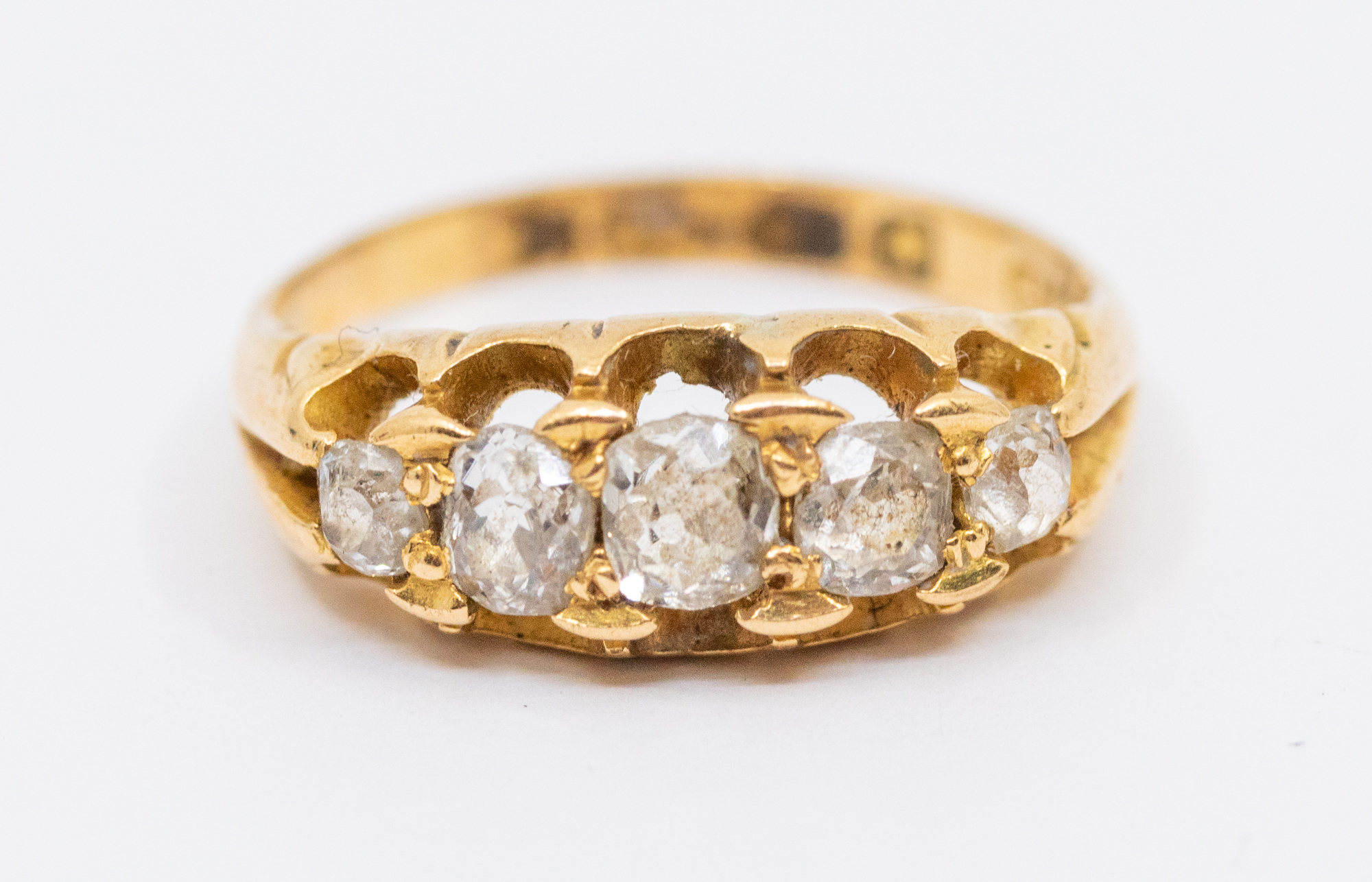 A diamond and 18ct gold boat head ring, comprising five graduated old European cut diamonds, claw