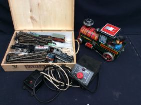 Collection of vintage train items, including tin plate and small train set.