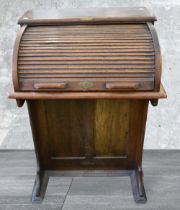 A mid 20th Century 'Amyl' tambour-fronted small desk/Canterbury in oak, having four drawers to