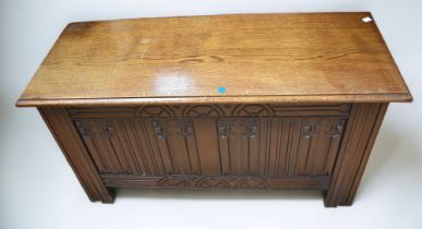 Mid 20th century oak linen box with linen fold front.