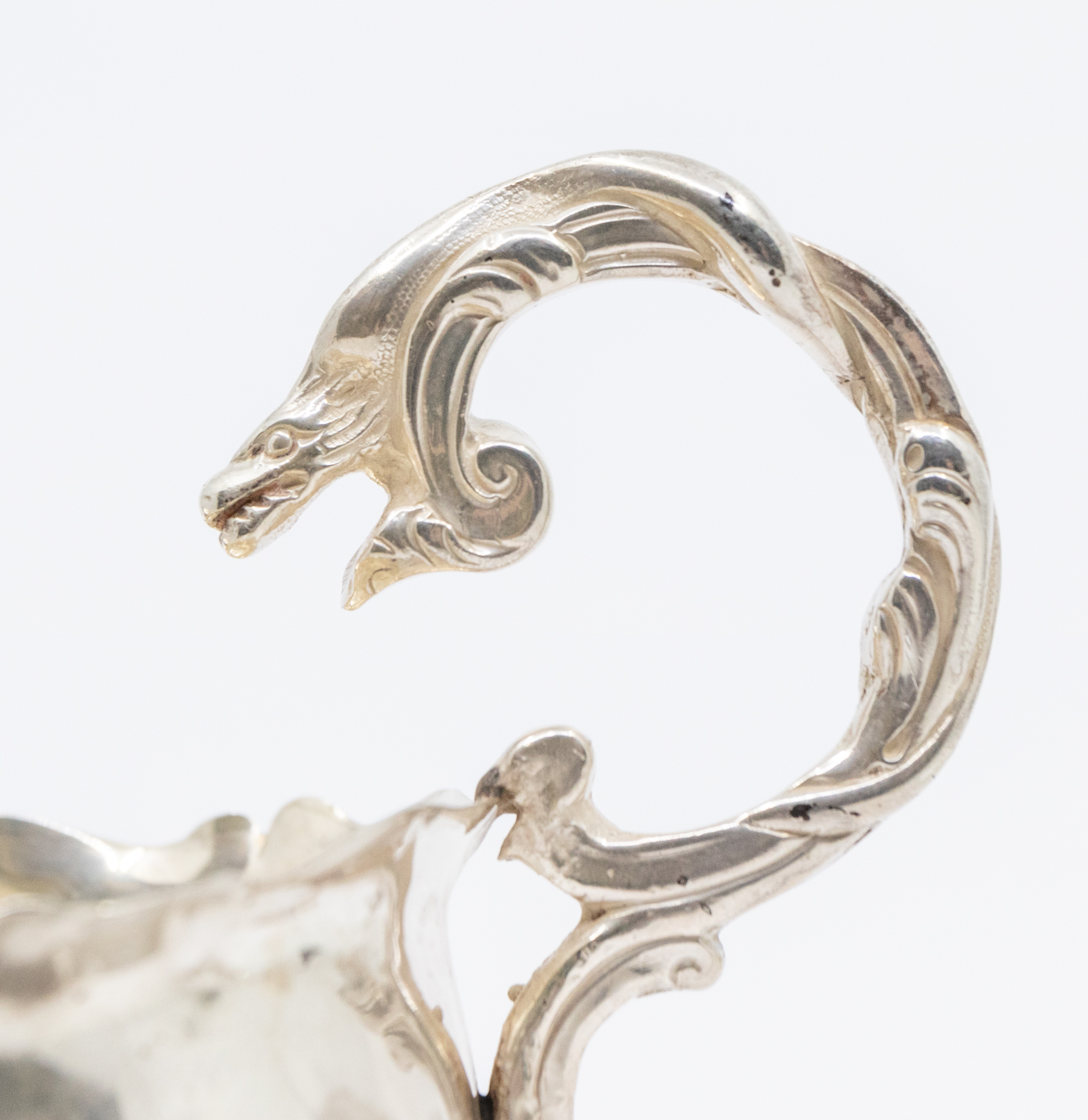 A George II silver sauceboat, with three shell shaped feet, single handle with mythical serpent - Image 2 of 3