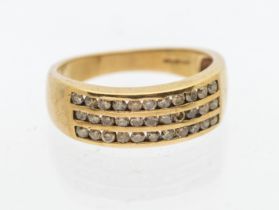 A diamond and 9ct gold dress ring, comprising three rows of channel set round brilliant cut cinnamon