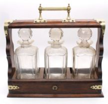 A mid 20th century, oak, three decanter tantalus with key