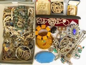 A collection of costume jewellery to include vintage paste set double clips, brooches, large