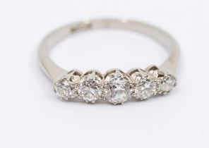 A five stone diamond and platinum ring, comprising a row of claw set graduated old cut diamonds,