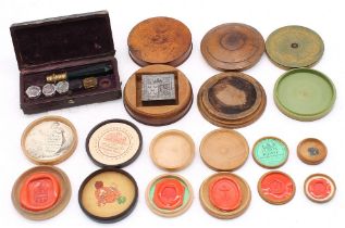 A 19th Century boxed set of five Tassie style varicoloured glass seals with engraved motto or