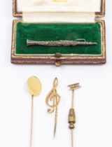 A collection of gold pins to include a 18ct gold pin with oval top and 9ct gold pin, weight approx