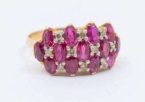 A ruby and diamond 9ct ring, comprising three rows of oval mixed cut rubies, each approx 3 x 4mm,