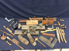 A collection of wooden vintage tools to include plains, gauges, squares and more.