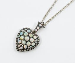 An opal and diamond set silver locket, comprising a heart form set with round cabochon opals, in