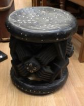 A mid 20th century ebonised African chief's seat inlaid with shells and French francs