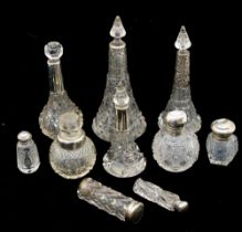 A collection of mixed silver topped or collared cut glass perfume bottles to include; three