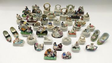 A large collection of late 19th century Continental porcelain trinket boxes with figure details on