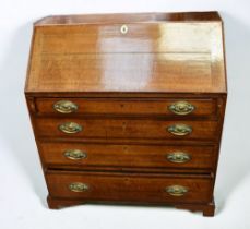 George III four drawer bureau in oak with bracket feet and brass swing handles, drop down writing