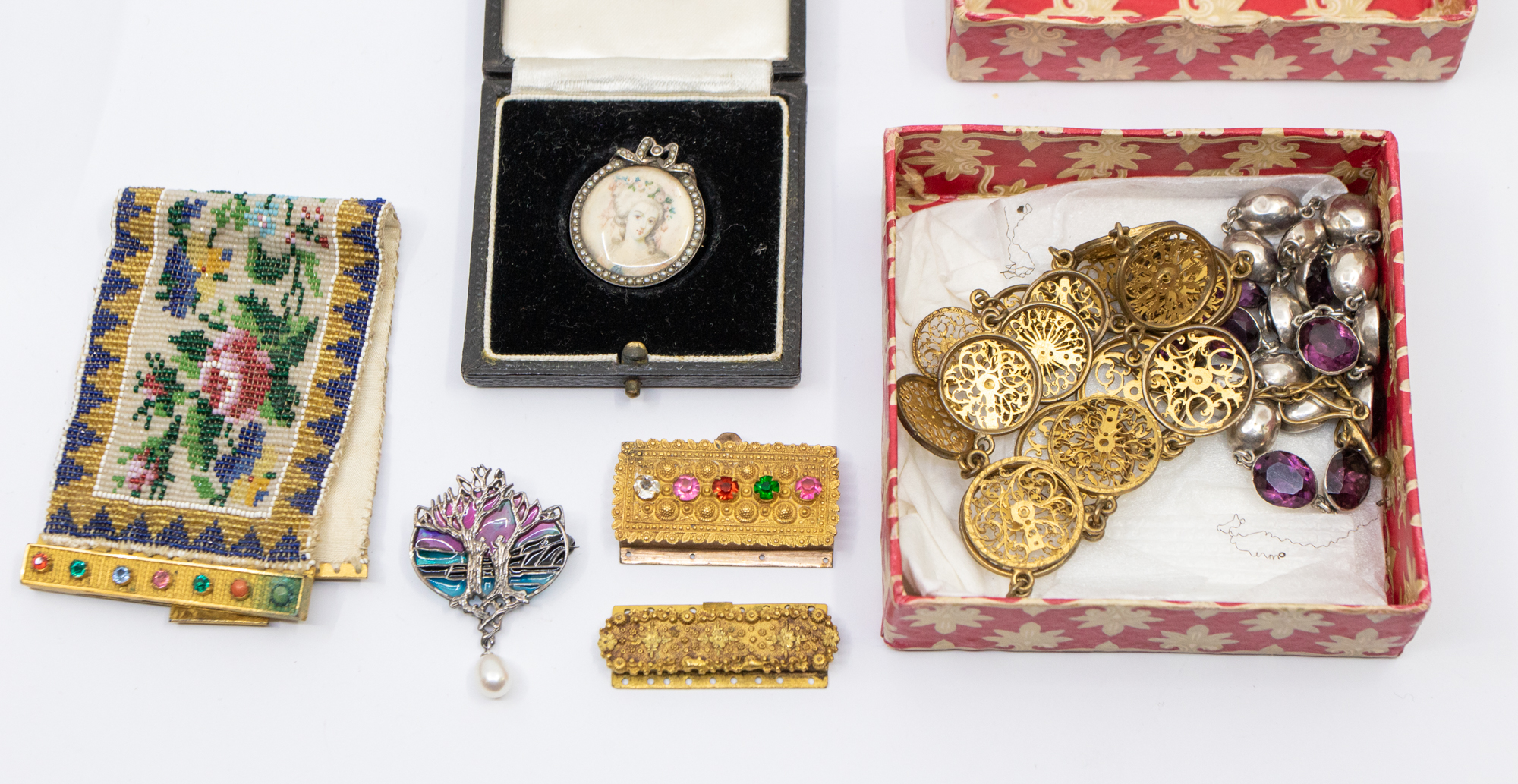 A collection of antique jewellery to include a gilt metal and paste bead work bracelet, with