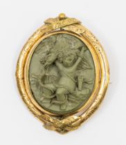 A Victorian gilt metal finely carved lava stone brooch, oval form depicting a mythical scene of a