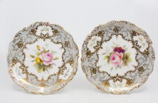 Coalport - Two similar hand painted floral decorated plates, fluted edged, signed by F. Howard. (