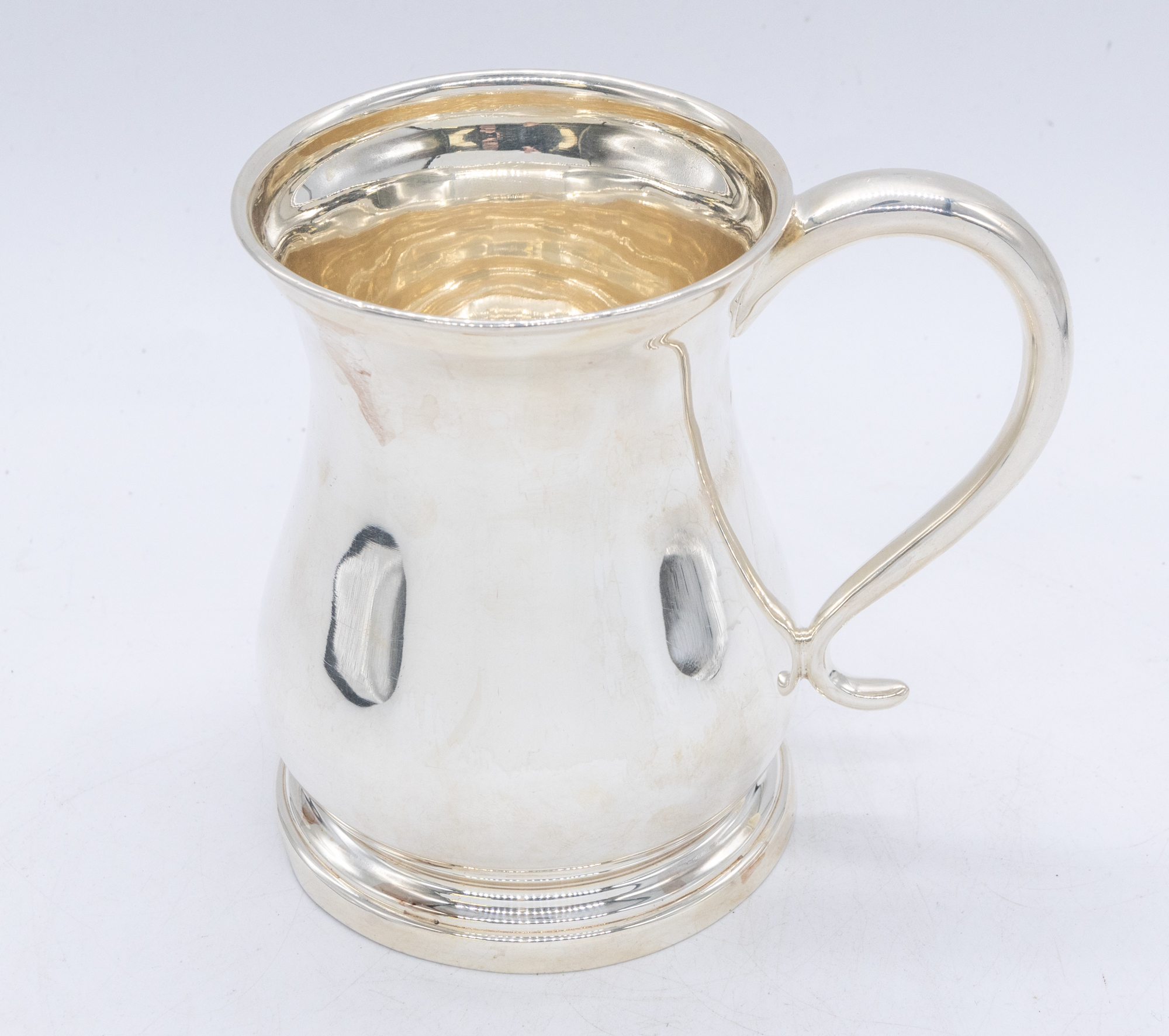 A George V silver tankard, of baluster form with stepped base, single handle to side, hallamrked