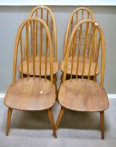 An Ercol dining table along with a set of late 20th century light Ercol spindle back kitchen