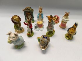 A collection of Royal Albert and Beswick Beattrix Potter figures along with two shakers.