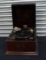 A 20th century oak cased Portland wind-up gramophone, with needle tin and record.