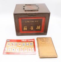 An early 20th century, most likely 1920s Mahjong set, being encased in a metal container with