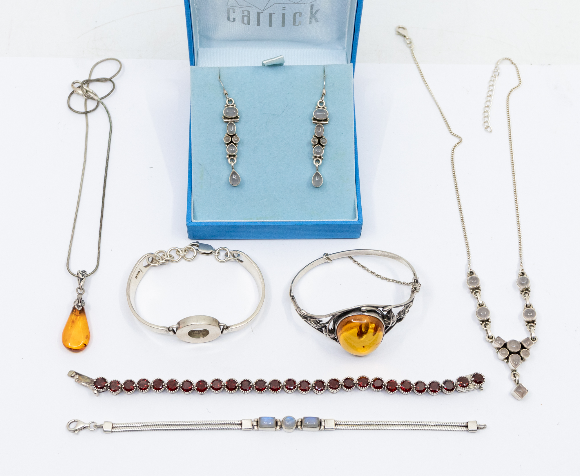 A collection of silver and stone set jewellery to include an amber bangle, comprising an oval