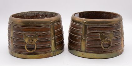 A pair of circular late 19th/early 20th century Tibetan wooden grain measures, with brass