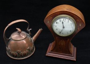 An early 20th century balloon shaped mahogany cased mantle clock with inlayed detail, along with