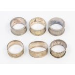 A collection of four various early 20th Century silver napkin rings, various dates and makers,