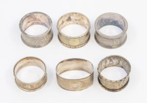 A collection of four various early 20th Century silver napkin rings, various dates and makers,