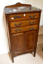 Edwardian mahogany music cabinet with three drawers above two cupboard doors on tapered legs, Also