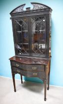 A reproduction 19th century style glazed cabinet with two drawer detachable base, on four legs and