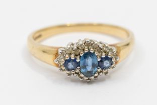 A sapphire and diamond set 9ct gold ring, comprising an oval mixed cut sapphire to the centre approx