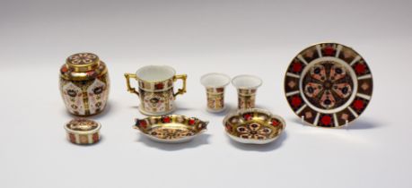 A collection of Royal Crown Derby 1128 Imari items to include pin dishes, posie vases, mug, plate