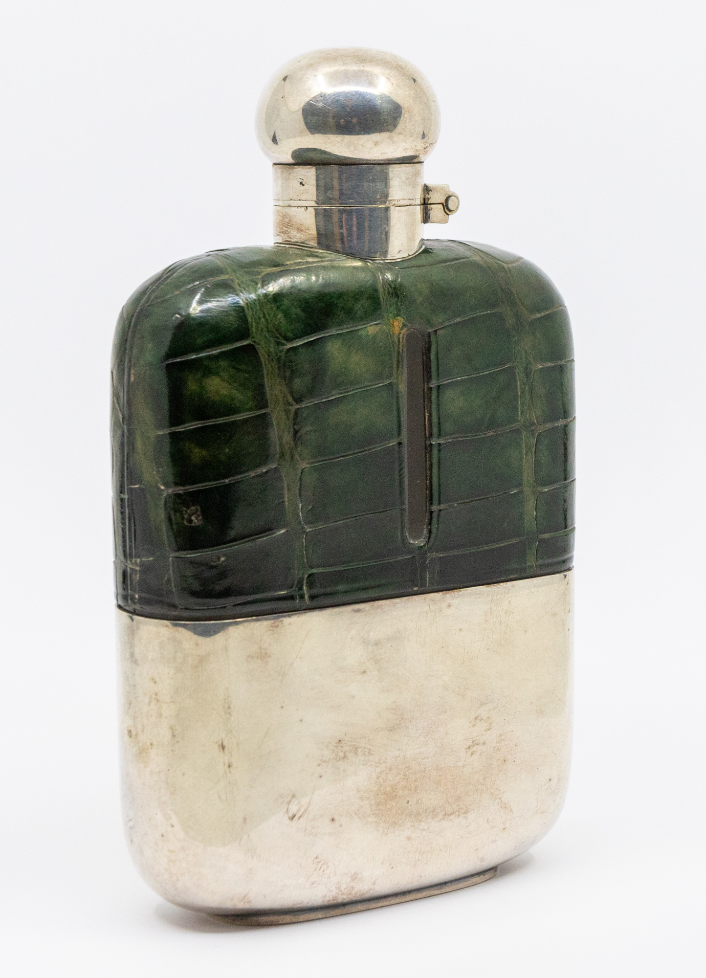 A 20th century silver plated hip flask with green crocodile skin leather surround and detachable