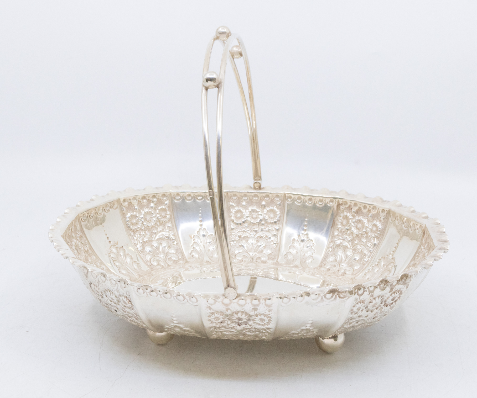 A late Victorian silver oval shaped centre basket/bowl, fluted edge with elaborate floral and