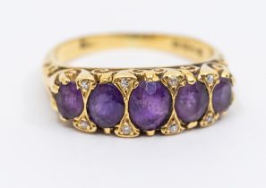 An amethyst and diamond 18ct gold ring, comprising five oval mixed cut graduated amethysts, inset