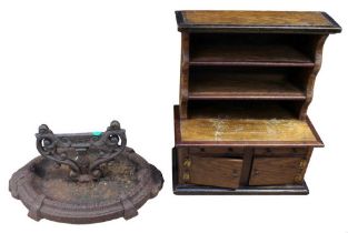 An early 20th century cast-iron boot scraper together with a miniature oak dresser