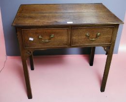 An 18th century two drawer lowboy brass swing handles, block square legs with decorative detail to