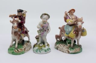 A pair of 20th century Samson figures of The Welch Tailor and Wife, sitting astride goats, base