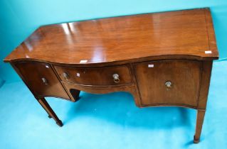 An Edwardian serpentine front mahogany sideboard in the George III style on spear legs, central