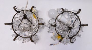 A pair of late 19th/early 20th century brass and crystal cut glass, small chandeliers, having many
