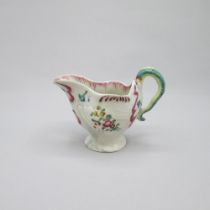 A rare Christians Liverpool polychrome Dolphin cream boat with a Lamprey handle, painted with flower