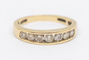 A diamond and gold half eternity ring, comprising a channel set row of round brilliant cut diamonds,