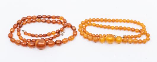 A collection of amber type bead necklaces, comprising one with graduated oval beads, the largest